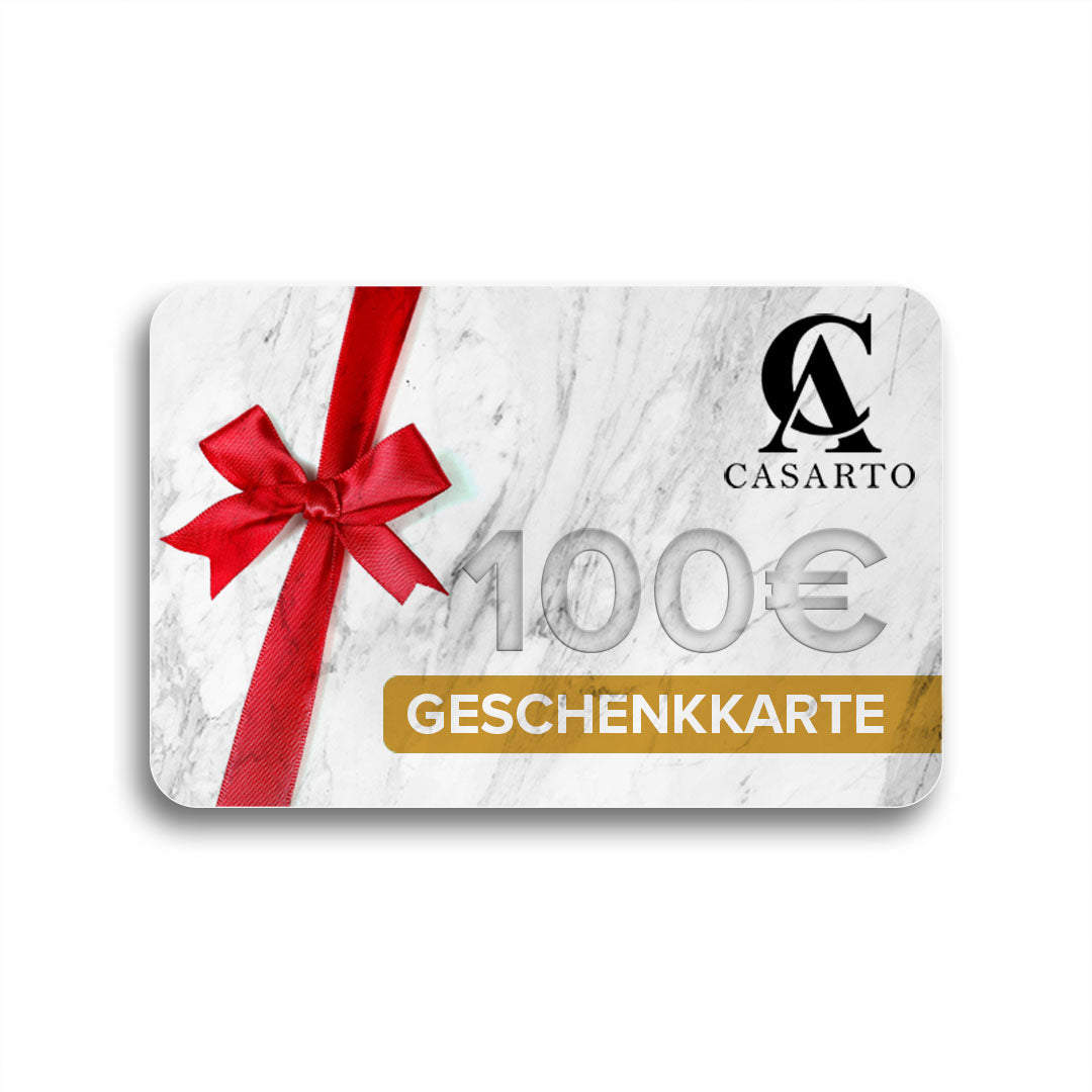 Geschenkkarte im Wert von 100 Euro mit roter Schleife auf weißem Marmor-Hintergrund